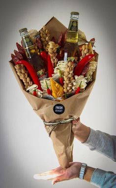 a person holding a paper bag full of food