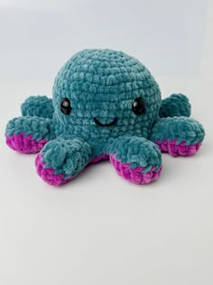 an octopus stuffed animal sitting on top of a white table