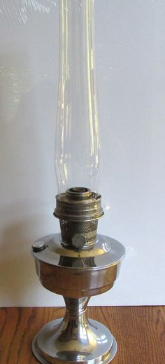 an old fashioned oil lamp on a wooden table