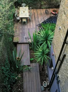 an aerial view of a wooden deck surrounded by greenery