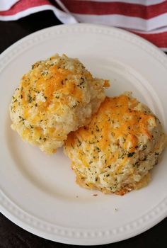 two biscuits on a white plate next to an american flag