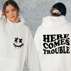 "Here Comes Trouble Sweatshirt, Front And Back Trouble Sweater, Sarcastic Humor Hoodie, Trouble Maker Gift, Funny Friends Sweatshirt This is Moko Shirt!   -Don't forget to see all the photos in listings for details like print color options and sizes and shirt colors.  -Use the drop-down menus to notify the sizes and colors of your shirts.  -Prices vary depend on the shirt sizes.  -Shirts are soft and regular relax fit. Below there are some information about my products and shop.  -Sweatshirt Mat White Band Merch Hoodie With Graphic Print, Band Merch White Hoodie With Graphic Print, White Hooded Band Merch Top, White Hooded Top With Band Merch, Trendy White Halloween Hoodie, White Slogan Hoodie For Fall, White Band Merch Hoodie For Fall, White Band Merch Hoodie Sweatshirt, White Band Merch Hoodie