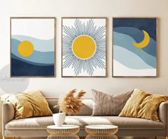 three paintings hang on the wall above a couch