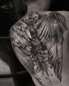 the back of a woman's thigh with an angel tattoo on it