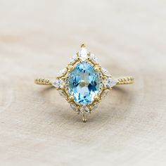 an aqua and white topaz ring with diamond accents