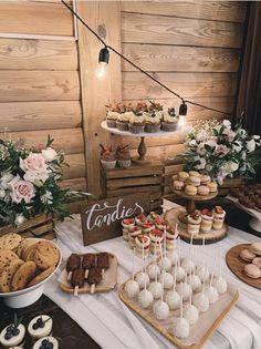 an assortment of desserts and cookies on display at a rustic wedding reception in the mountains