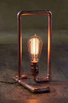 a lamp that is sitting on top of a wooden table next to an electrical device