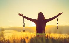 a woman with her arms outstretched in front of the sun, holding chains and saying you will make it out i promise