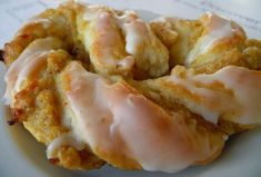 a white plate topped with donuts covered in icing