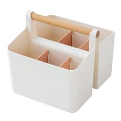 two white storage containers with wooden handles and dividers on each side, one holding compartments for pens and pencils