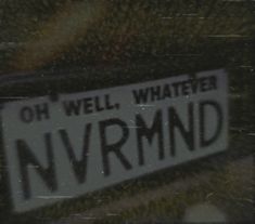 a street sign that reads, oh well whatever nvrmnd on it's side