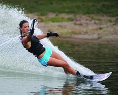 a woman is water skiing in the lake