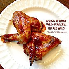 two chicken wings on a white plate with the words quick and easy over - barbecued chicken wings