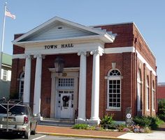 a truck parked in front of a town hall