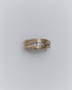 a gold ring with three diamonds on it