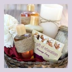 a basket filled with soaps, candles and personal care items on top of a table