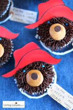 some cupcakes with chocolate frosting and decorations on them are shaped like hedgehogs