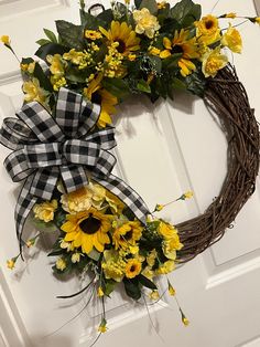 a sunflower wreath is hanging on the front door