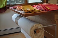 the table is covered with various fabrics and other items that are on top of it