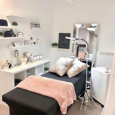 a room with a bed, desk and shelves on the wall next to each other