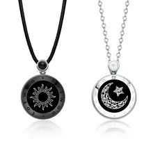 two necklaces with black and white designs on them, one has a sun and the other is a moon