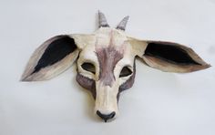 an animal's head is made out of wood and has horns on the side