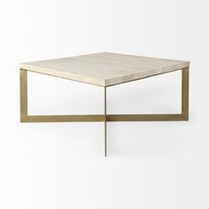 a square coffee table with gold metal legs