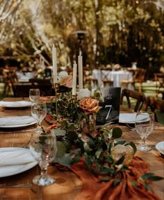 the table is set with candles and place settings