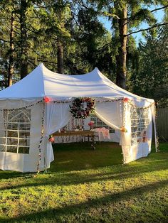 a white tent set up in the grass