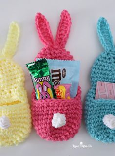 three crocheted bunny bags with candy in them