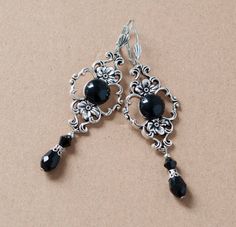 These elegant earrings are made from round black agate stone set in antique silver filigree setting, embellished with black waterdrop beads at the bottom. They will make a beautiful accessory for someone who loves Victorian or vintage style. -The earrings are 2.5 inches long, without the lever back closure and an inch wide at the widest part of the filigree setting -They have a lever back closure (lead and nickel free) SHIPPING: Default shipping is by regular mail, which does not have tracking, Black Dangling Earrings, Elegant Black Filigree Earrings, Black Filigree Dangle Jewelry, Black Nickel-free Earrings For Wedding, Nickel-free Black Earrings For Wedding, Nickel-free Black Wedding Earrings, Elegant Black Oxidized Finish Earrings, Black Elegant Chandelier Earrings, Nickel Free, 1800s Earrings