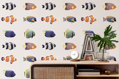 the wallpaper in this room is very colorful and has fish on it, as well as a plant