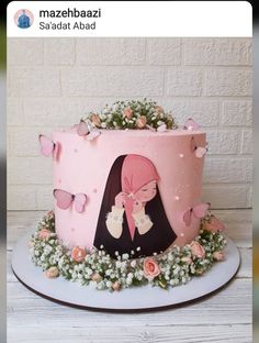 a pink cake decorated with flowers and butterflies