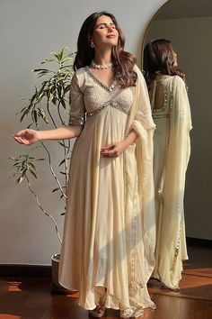 Beige anarkali featuring chikankari and mirror embroidery on the yoke and sleeve hem. Paired with a pant and mirror embroidered hem dupatta. - Aza Fashions Aesthetic Anarkali Dress, Western Silk Dress, Kurti Set For Wedding, Traditional Indian Dresses For Women, Anarkali With Yoke, New Wedding Outfits Indian, Beige Anarkali Dress, Wedding Dresses Suit, Kurta Designs Women Chikankari