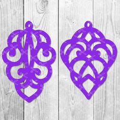 two purple paper cut outs with an ornate design on them