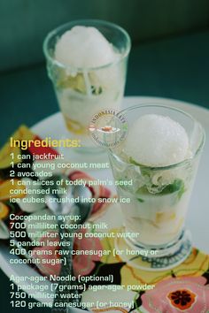 two glasses filled with ice sitting on top of a white plate next to each other