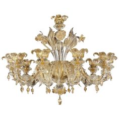 an ornate chandelier with golden glass flowers and leaves on the bottom half of it