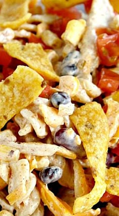 a bowl filled with chips and vegetables on top of a table