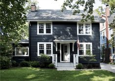 a black house with white trim and windows