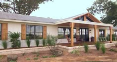 a white house with wood trim and windows