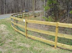 a wooden fence along the side of a road