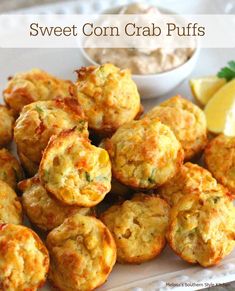 sweet corn crab puffs on a white plate with lemon wedges next to it