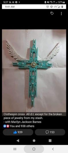 the cross is made out of plastic and has wings on it