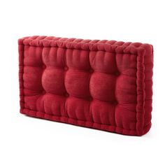 a red couch cushion sitting on top of a white floor