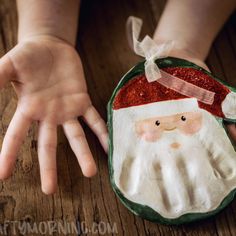 hand print keepsake craft with santa clause on it's back and hands in the air