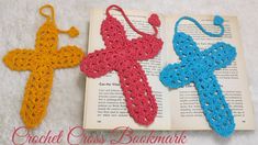 two crocheted cross bookmarks laying on top of an open book