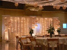 a banquet hall decorated with lights and flowers