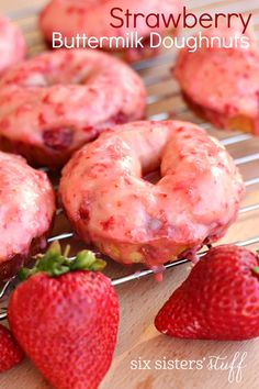 strawberry donuts on a cooling rack with strawberries