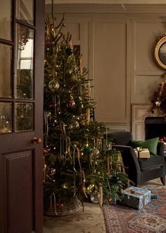 a living room with a christmas tree in the corner