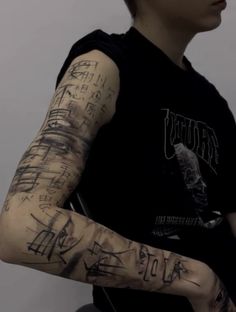 a man with lots of writing on his arm